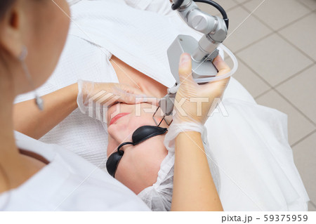 beauty clinic employee does hair removal using laser 59375959