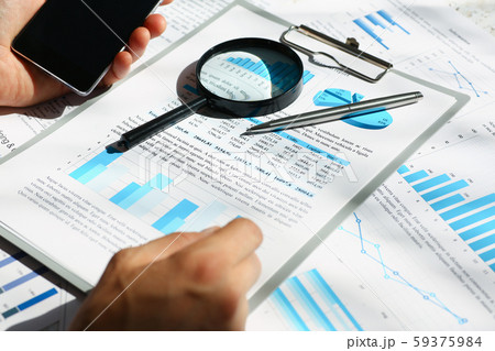 Financial statistics documents on clipboard pad at office table closeup 59375984