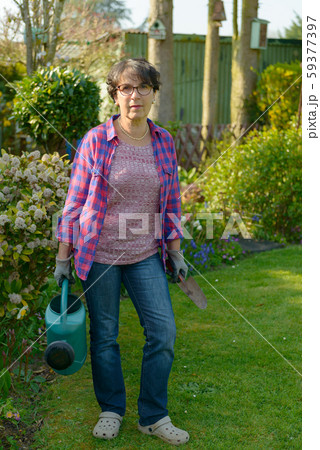 woman gardening in her beautiful garden. 59377397