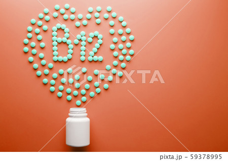 Vitamins B 12 in the shape of a heart on a red Vitamins B 12 in the shape of a heart on a red 59378995
