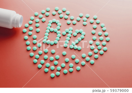 Vitamins B 12 in the shape of a heart on a red 59379000
