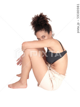 Beautiful multi-racial woman sitting on the floor 59380981