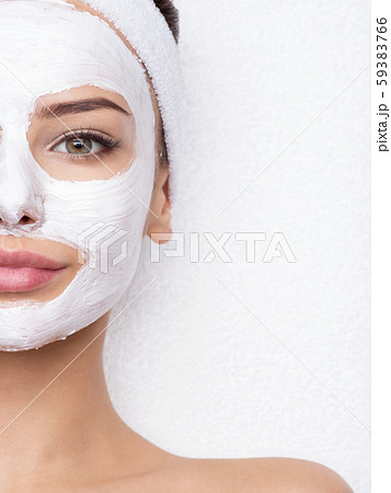 woman relaxing in spa salon with cosmetic mask on 59383766