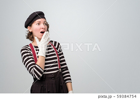 Young caucasian mime woman looking up in surprise. Young caucasian mime woman looking up in surprise. 59384754