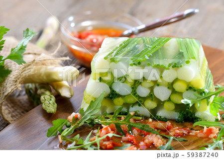 Asparagus jelly with fresh white and green asparagus and chives, served with red pepper vinaigrette 59387240