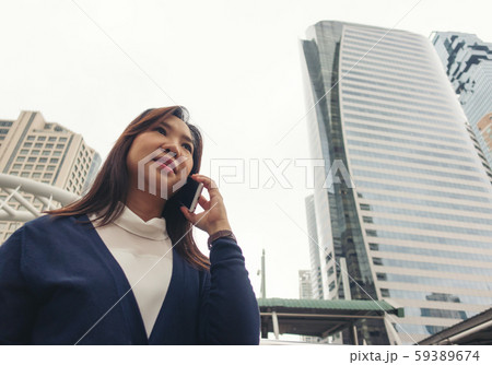 woman walking outdoor and talking on mobile phone 59389674
