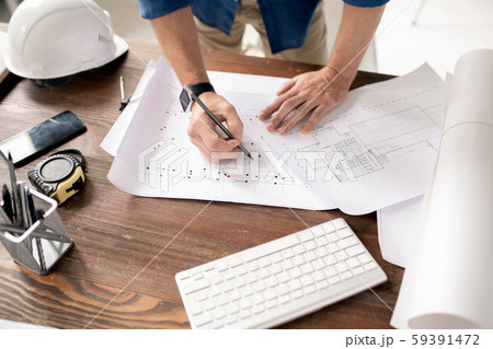Hands of modern engineer with pencil drawing sketch of building construction Hands of modern engineer with pencil drawing sketch of building construction 59391472