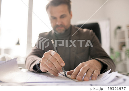 Hands of architect with pencil and ruler drawing line while making sketch Hands of architect with pencil and ruler drawing line while making sketch 59391977