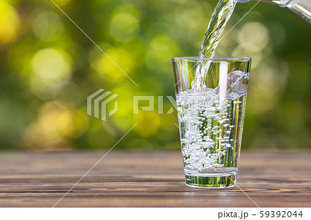 water pouring into glass water pouring into glass 59392044