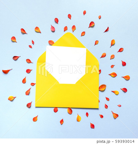 Envelope of orange color inside which is a blank white sheet of paper. 59393014