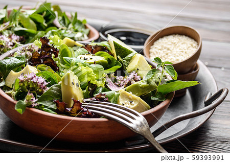 Clay dish with salad of avocado, green and violet Clay dish with salad of avocado, green and violet 59393991