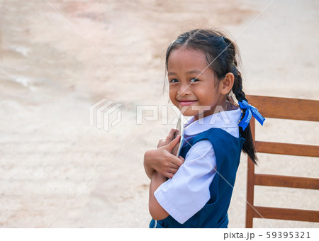 Happy little girl holding tablet PC outdoors in 59395321