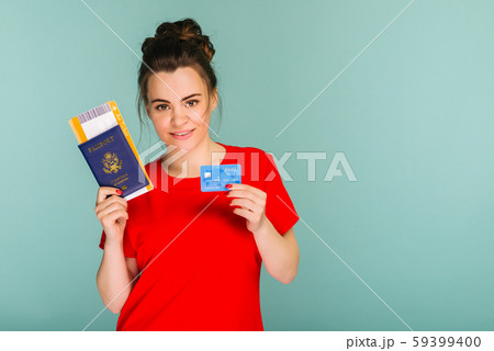 Young smiling student holding passport pass ticket 59399400