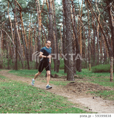 Man runner run in the outdoor pine forest Man runner run in the outdoor pine forest 59399838