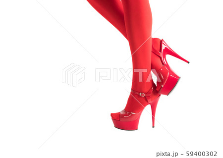 Flirty female feet in fetish red stockings and high heels, isolated on white. 59400302