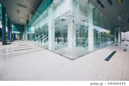 Modern empty office buildings with glass wall and empty pavement . 59400445