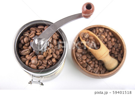 Coffee beans in a coffee grinder and a wooden bowl Coffee beans in a coffee grinder and a wooden bowl 59401518