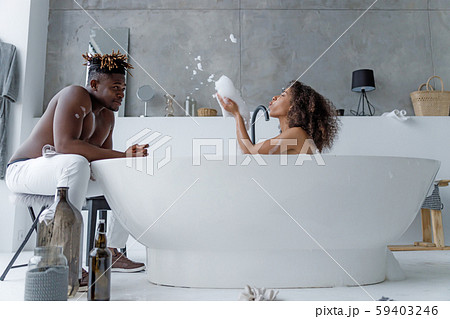 Cute young woman taking bath and having fun with her boyfriend Cute young woman taking bath and having fun with her boyfriend 59403246