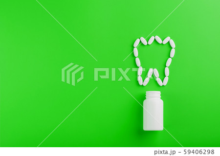 Calcium vitamin in the form of a tooth spilled out Calcium vitamin in the form of a tooth spilled out 59406298