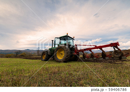 Tractor plowing fields. Tractor plowing fields. 59406786