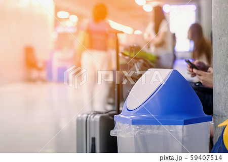 Blue cover transparent trashcan for increasing safety measures placed on the floor in the airport. Blue cover transparent trashcan for increasing safety measures placed on the floor in the airport. 59407514