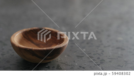 empty olive wood bowl on terrazzo surface 59408302