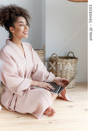 Cheerful young woman using modern laptop at home Cheerful young woman using modern laptop at home 59408303