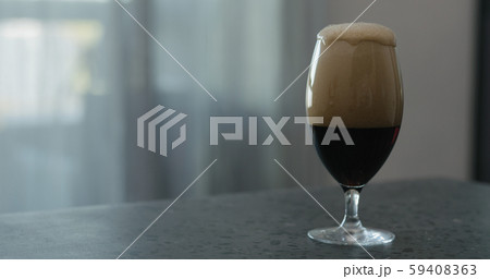 stout beer drops slide from tulip glass on terrazzo countertop with copy space stout beer drops slide from tulip glass on terrazzo countertop with copy space 59408363