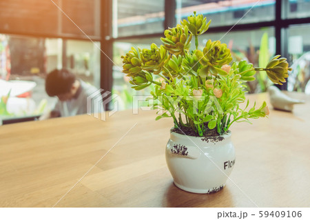 Artificial plants or plastic tree on table for decoration and welcome for customers in coffee shop. 59409106