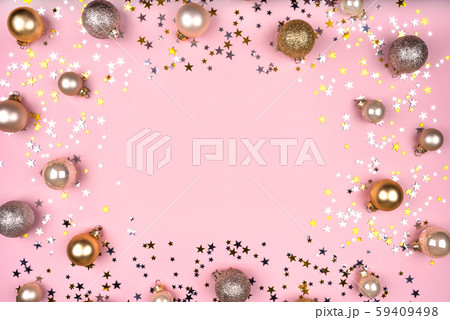 Festive pink background with gold and silver stars and Christmas balls. Festive pink background with gold and silver stars and Christmas balls. 59409498