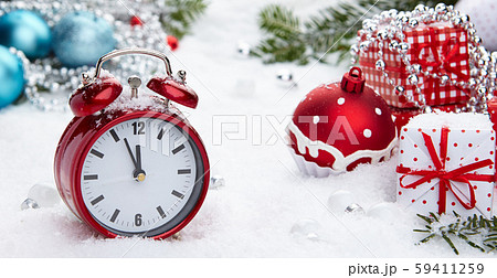 Red vintage alarm clock in the snow 59411259