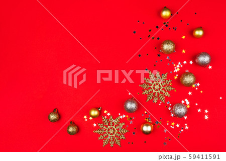 Festive red background with gold and silver stars and Christmas balls. 59411591