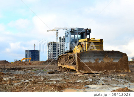 Bulldozer during of large construction jobs at building site Bulldozer during of large construction jobs at building site 59412028