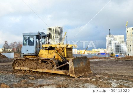 Bulldozer during of large construction jobs at building site Bulldozer during of large construction jobs at building site 59412029