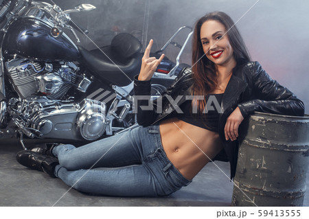 Young woman with motorcycle studio 59413555