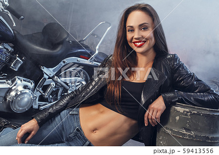 Young woman with motorcycle studio 59413556