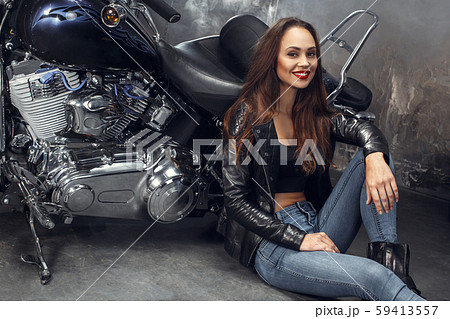Young woman with motorcycle studio 59413557