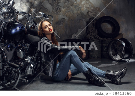 Young woman with motorcycle studio 59413560