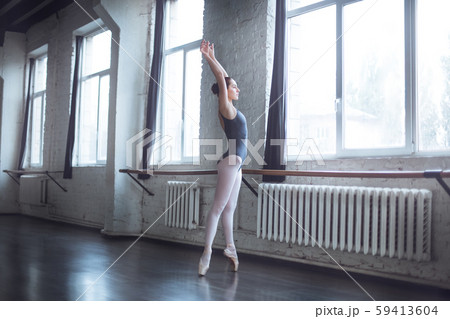 Young ballet dancer practice looking out the window in studio active lifestyle 59413604
