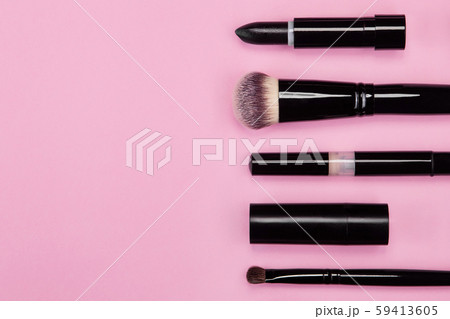 Set of brushes and cosmetic products on a pink background Set of brushes and cosmetic products on a pink background 59413605