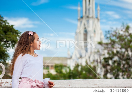 Girl on the Ortiz Bridge looking at the famous gothic church of La Ermita built on 1602 in Cali 59413890