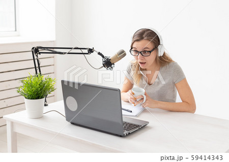 Radio host concept - Young woman working as radio host at radio station 59414343