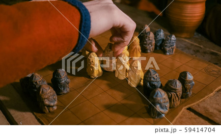 Two men playing popular strategy board game - tafl Two men playing popular strategy board game - tafl 59414704