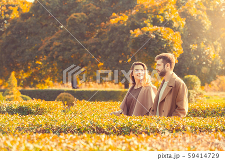 Young couple walk in the autumn park Young couple walk in the autumn park 59414729
