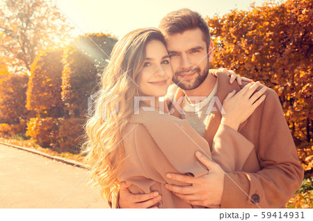 Young couple walk in the autumn park Young couple walk in the autumn park 59414931