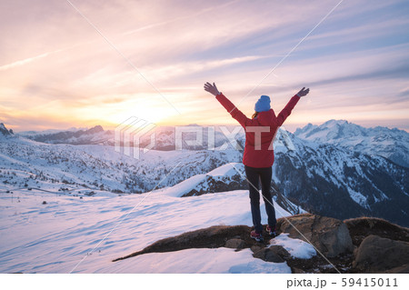 Happy young woman in snowy mountains at sunset in winter 59415011