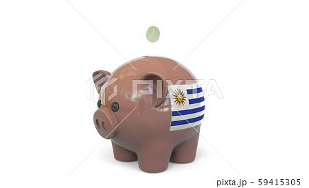 Putting money into piggy bank with flag of Uruguay. Tax system system or savings related conceptual Putting money into piggy bank with flag of Uruguay. Tax system system or savings related conceptual 59415305