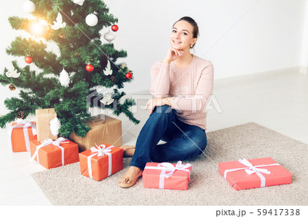 christmas, x-mas, winter, happiness concept - girl opens a gift against the background of the christmas, x-mas, winter, happiness concept - girl opens a gift against the background of the 59417338