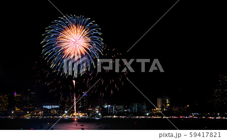 Happy new year fireworks over cityscape at 59417821