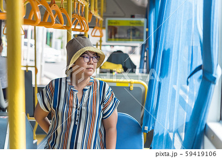 Asian woman travel by passenger bus in city Asian woman travel by passenger bus in city 59419106